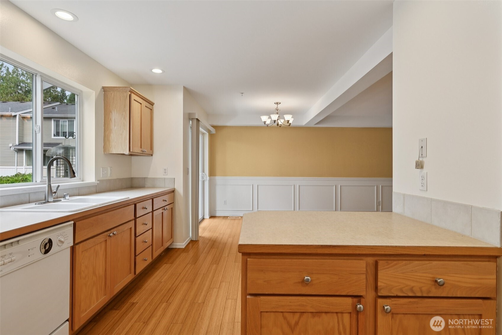5502 240th Street Southwest, Unit C304 Mountlake Terrace, WA 98043 - Photo 12 of 30 a kitchen with stainless steel appliances granite countertop a sink and cabinets