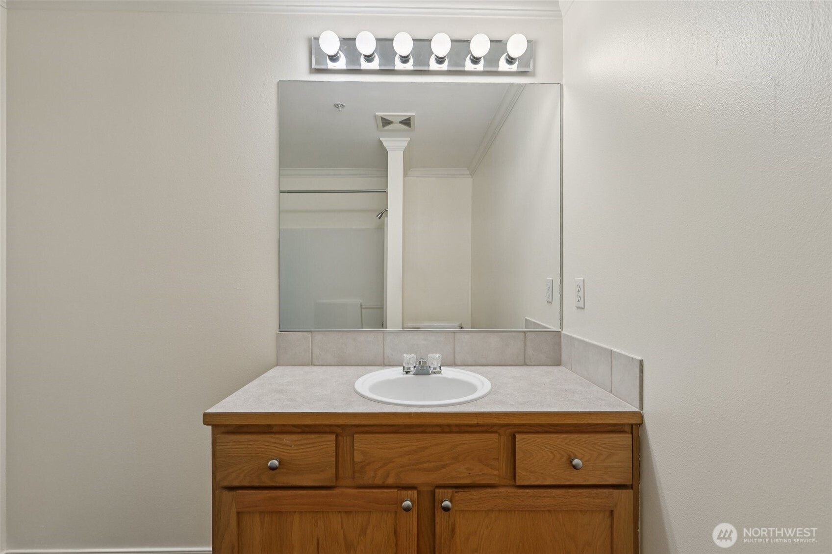 5502 240th Street Southwest, Unit C304 Mountlake Terrace, WA 98043 - Photo 18 of 30 a bathroom with a sink and a mirror