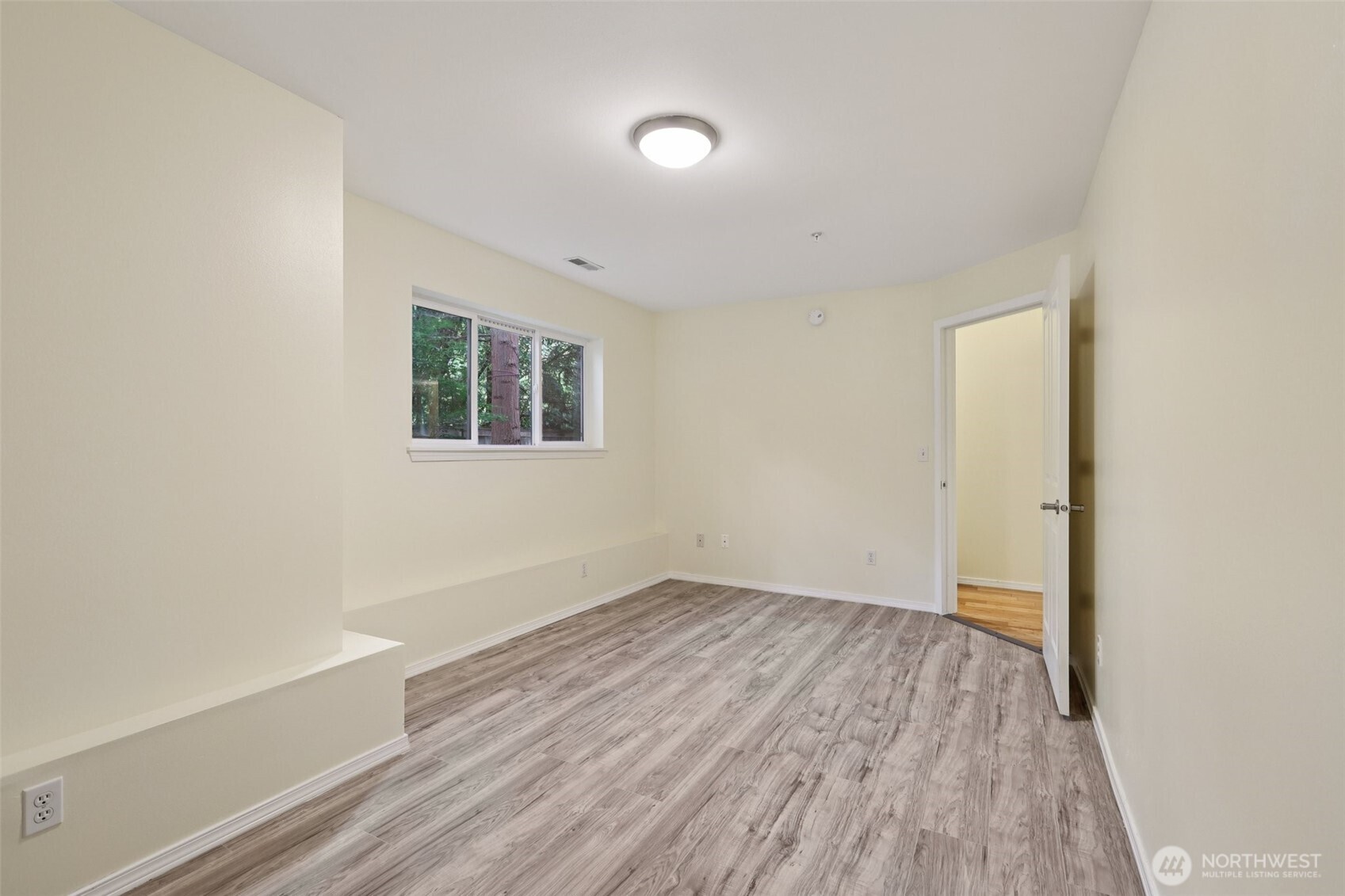 5502 240th Street Southwest, Unit C304 Mountlake Terrace, WA 98043 - Photo 4 of 30 an empty room with wooden floor and windows