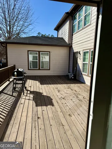 a view of backyard with wooden deck