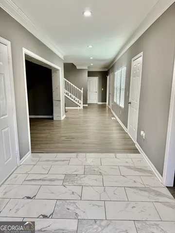 a view of a hallway with closet and window