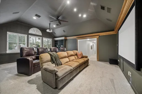 a living room with furniture a large window and a chandelier