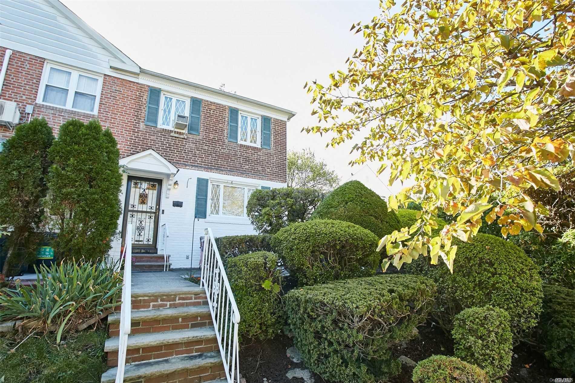 176-12 77th Road Queens, NY 11366 - Photo 1 of 20 a view of a house with a yard and plants