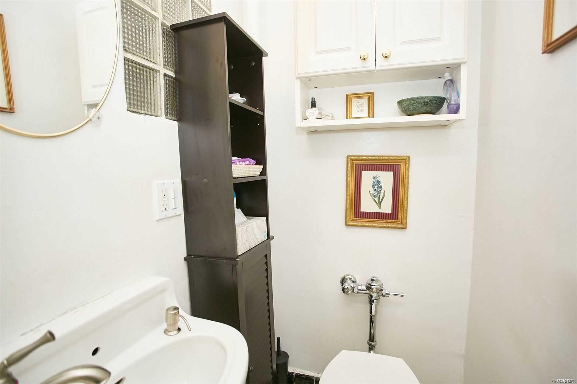 176-12 77th Road Queens, NY 11366 - Photo 11 of 20 a bathroom with a sink and mirror