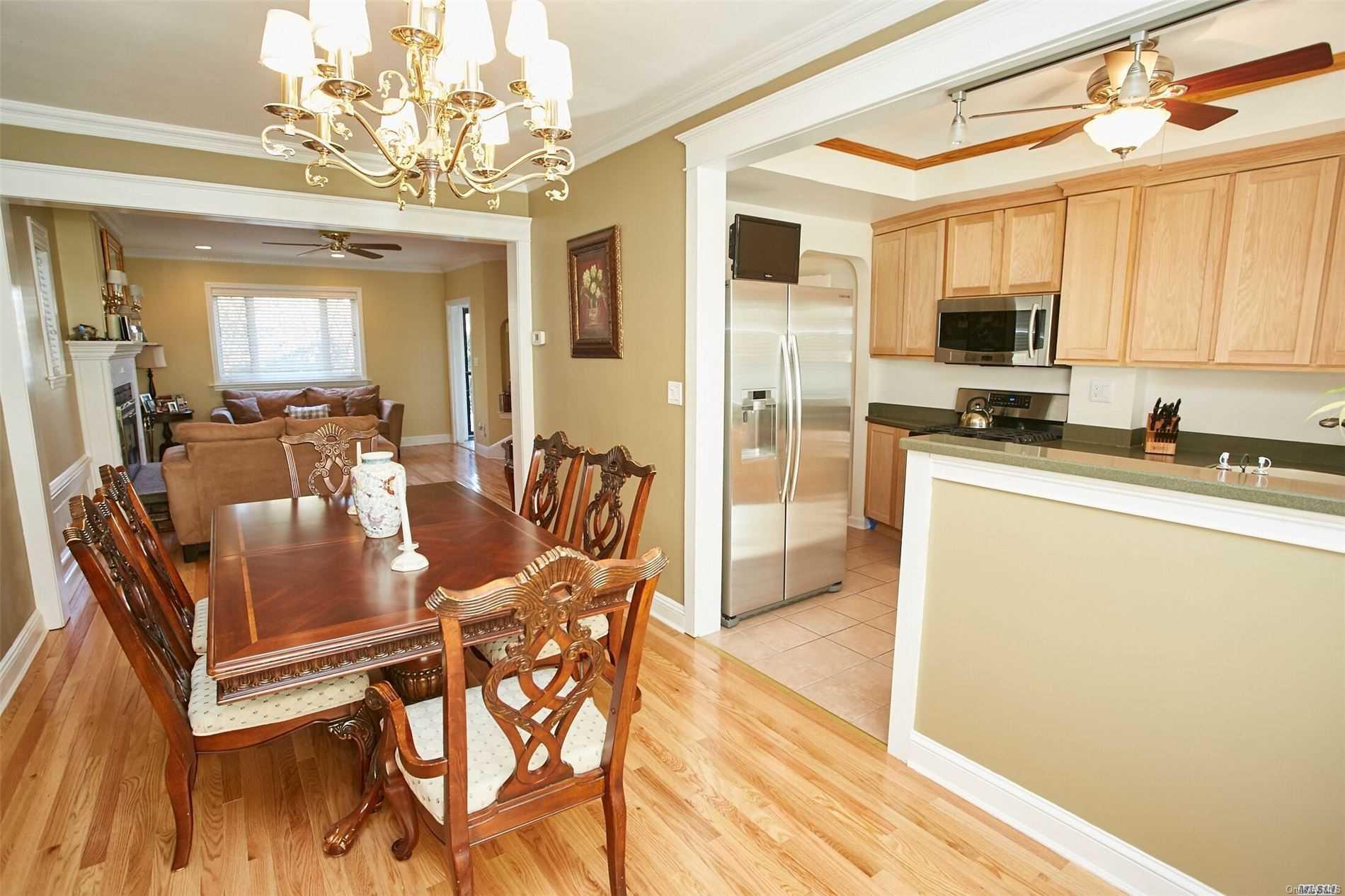 176-12 77th Road Queens, NY 11366 - Photo 13 of 20 a view of a dining room with furniture a chandelier and wooden floor