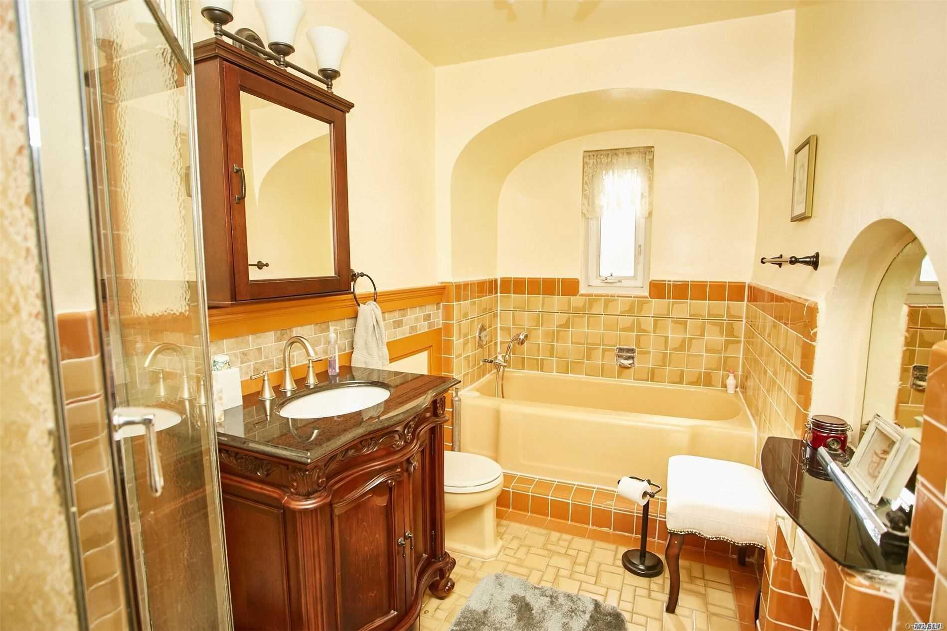 176-12 77th Road Queens, NY 11366 - Photo 14 of 20 a bathroom with a sink and a mirror