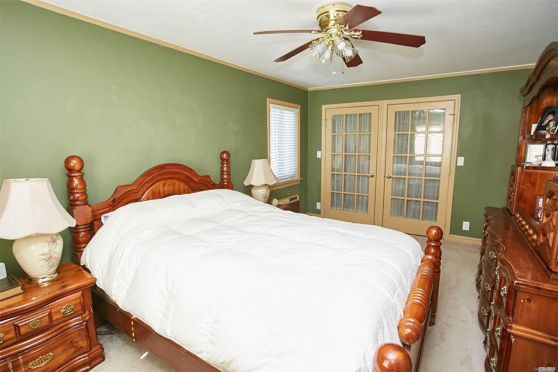 176-12 77th Road Queens, NY 11366 - Photo 15 of 20 a bedroom with bed and wooden floor