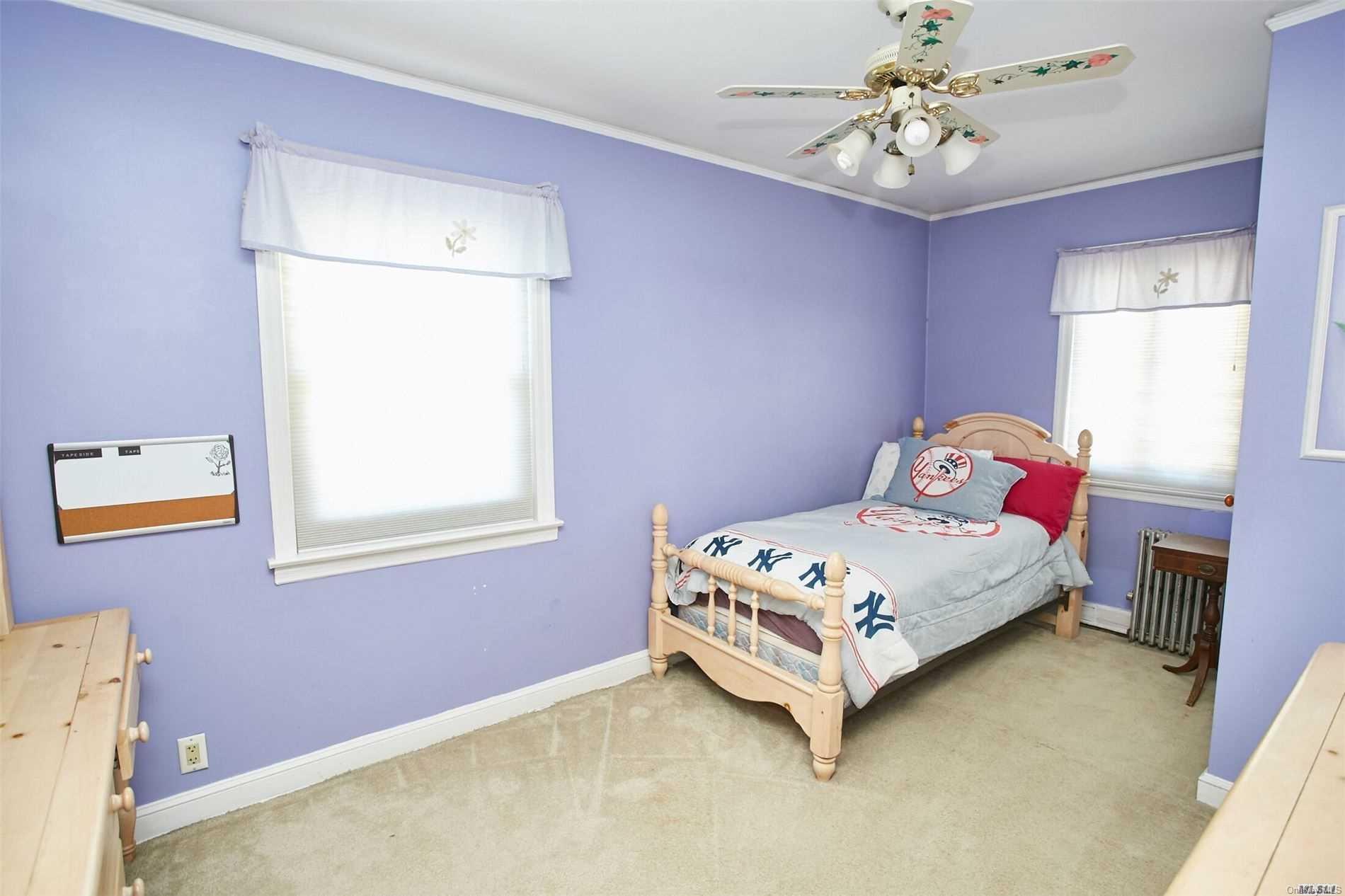 176-12 77th Road Queens, NY 11366 - Photo 16 of 20 a bedroom with a bed and window