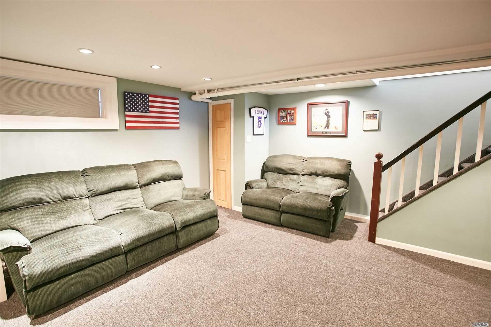 176-12 77th Road Queens, NY 11366 - Photo 19 of 20 a living room with furniture and a couch