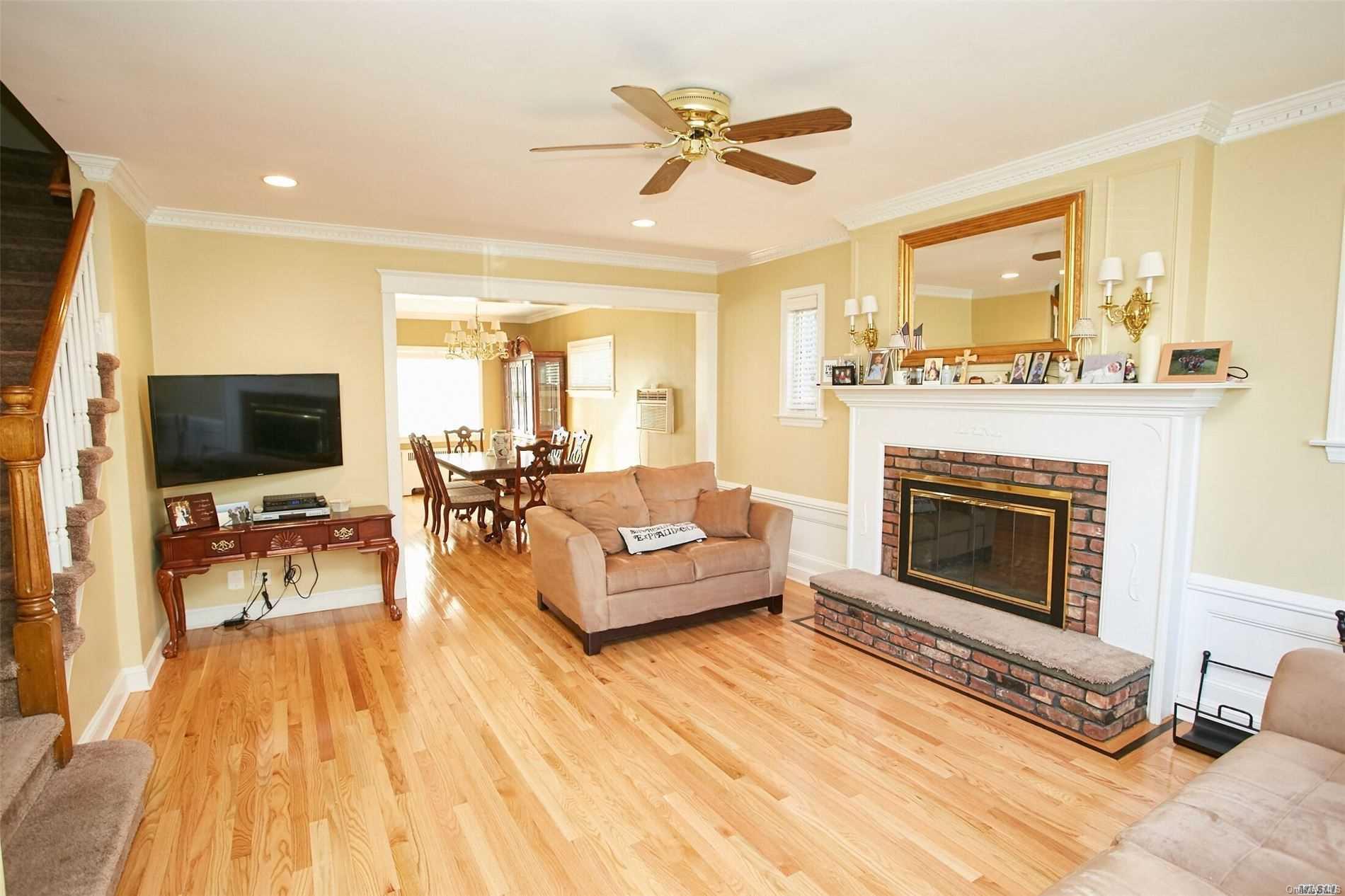 176-12 77th Road Queens, NY 11366 - Photo 2 of 20 a living room with furniture and a fireplace