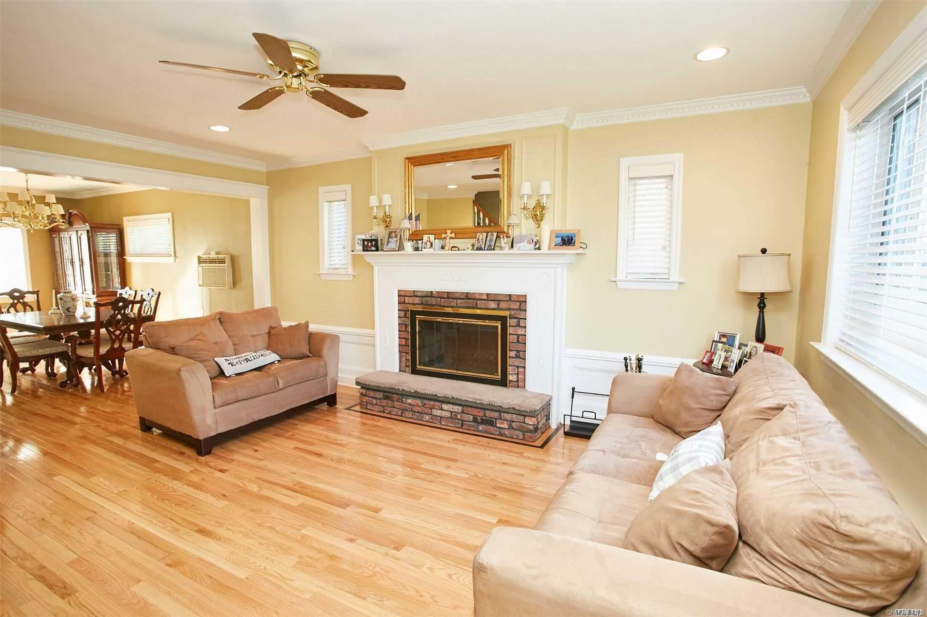 176-12 77th Road Queens, NY 11366 - Photo 3 of 20 a living room with furniture and a fireplace