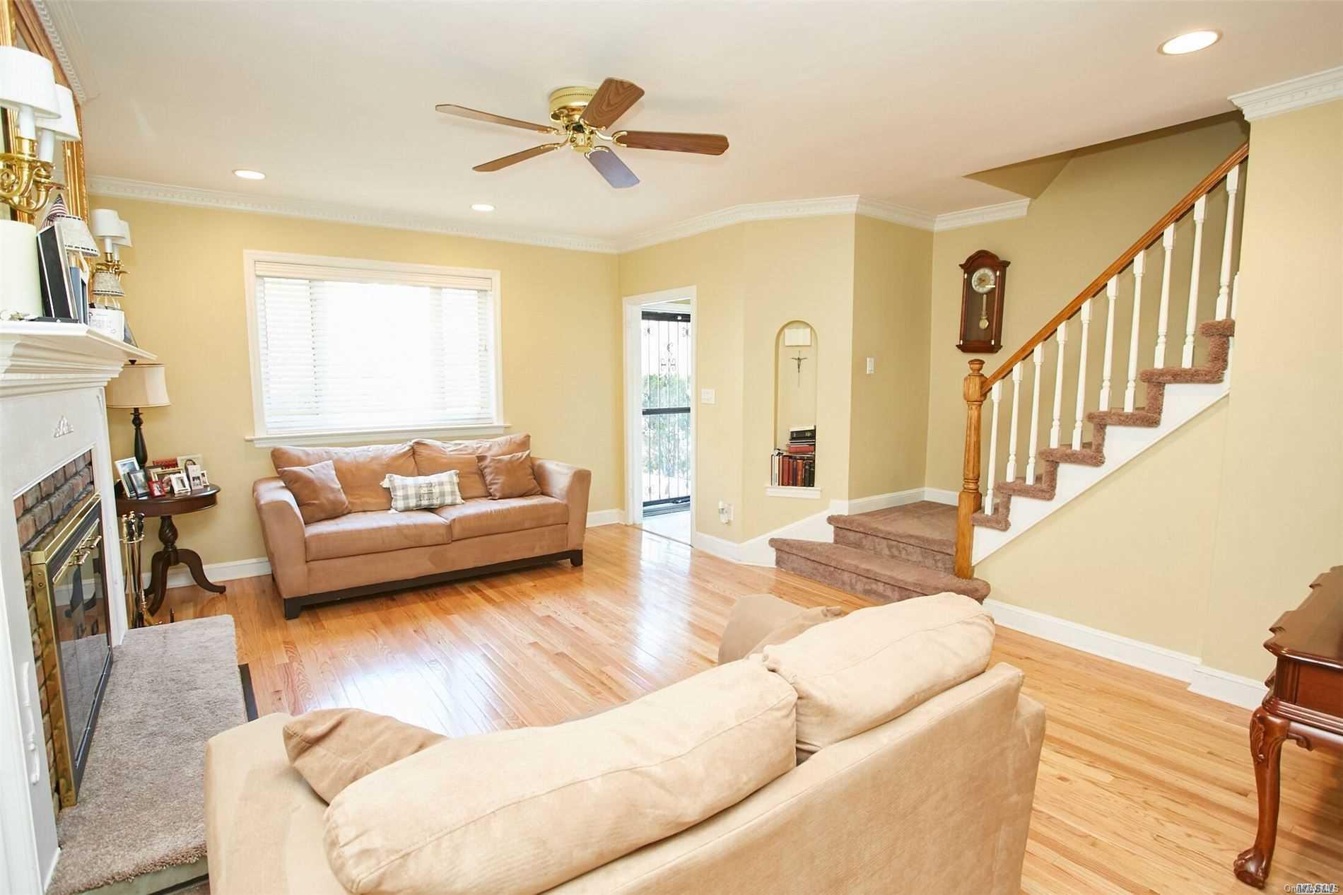 176-12 77th Road Queens, NY 11366 - Photo 4 of 20 a living room with furniture and a fireplace