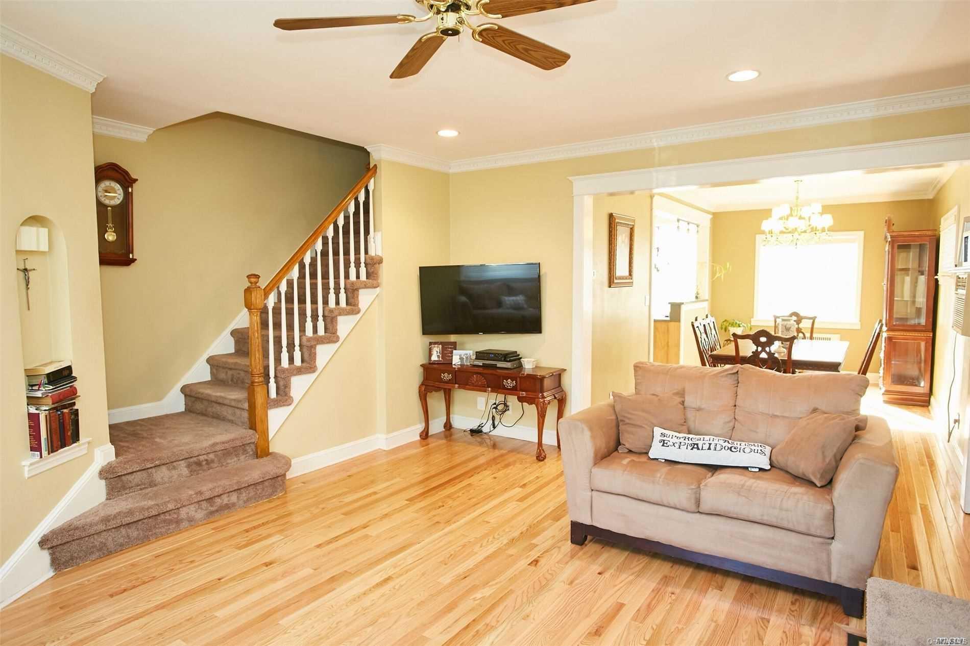 176-12 77th Road Queens, NY 11366 - Photo 5 of 20 a living room with furniture and a flat screen tv