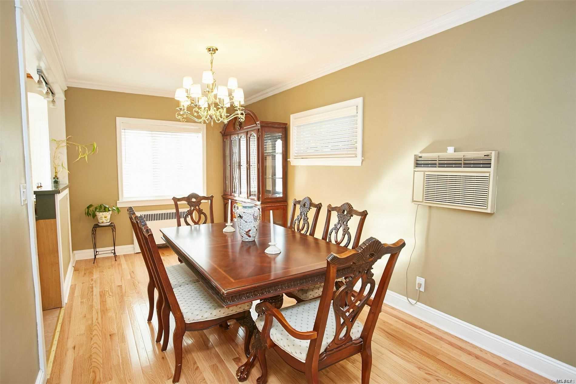176-12 77th Road Queens, NY 11366 - Photo 6 of 20 a view of a dining room with furniture and a chandelier