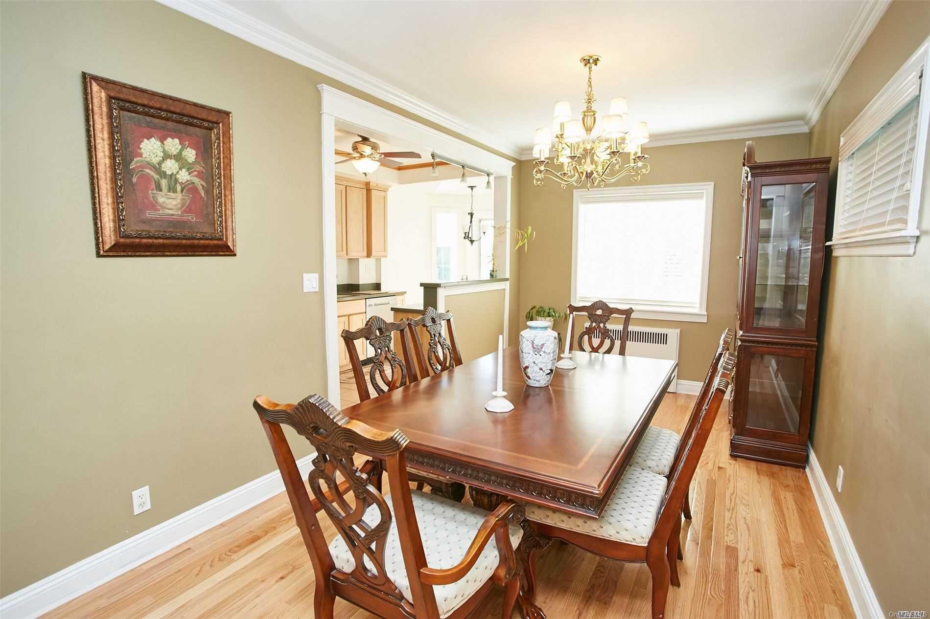 176-12 77th Road Queens, NY 11366 - Photo 7 of 20 a view of a dining room with furniture window and wooden floor