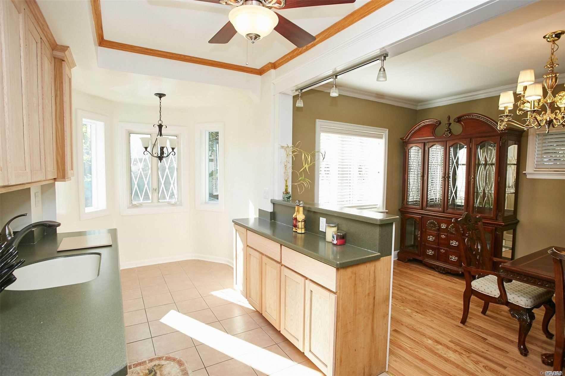 176-12 77th Road Queens, NY 11366 - Photo 9 of 20 a spacious bathroom with a double vanity sink a mirror a bathtub and next to a window