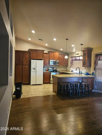 a large kitchen with stainless steel appliances granite countertop a large counter top and a stove