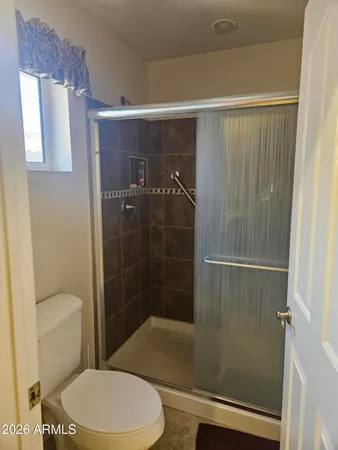 a bathroom with a toilet and shower