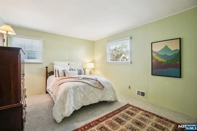 a bed room with a bed and a painting on the wall