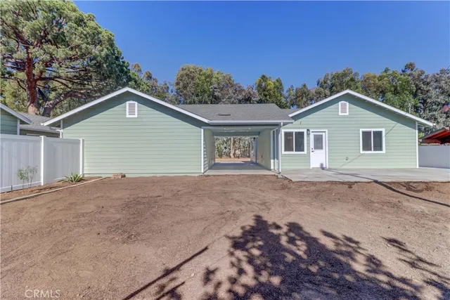 a view of a house with a yard and potted plants