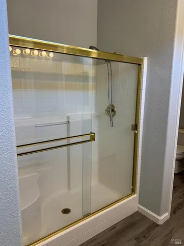 a bathroom with a glass shower door