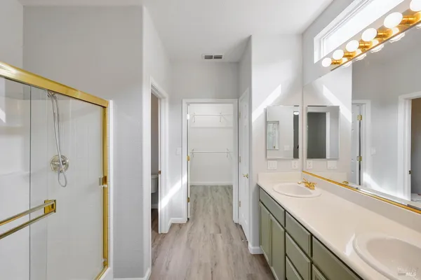 a spacious bathroom with a double vanity sink and a mirror