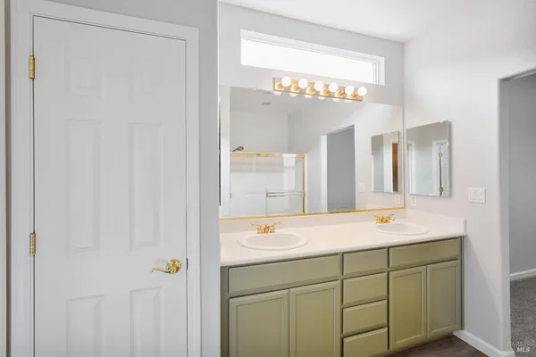 a bathroom with a glass shower door