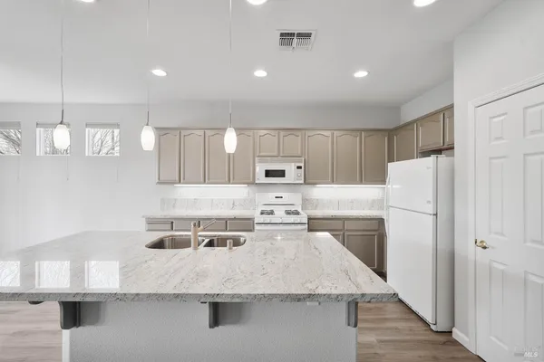 a kitchen with a appliances a refrigerator and a stove