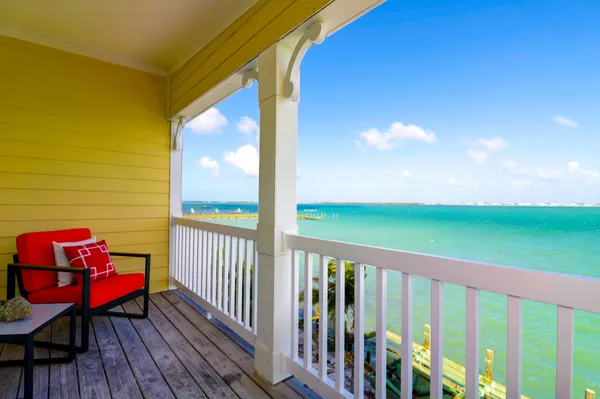 a view of a balcony with chair and wooden floor
