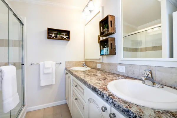 a bathroom with a granite countertop sink and a mirror