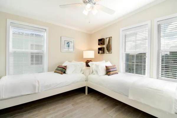 a bedroom with bed and a large window