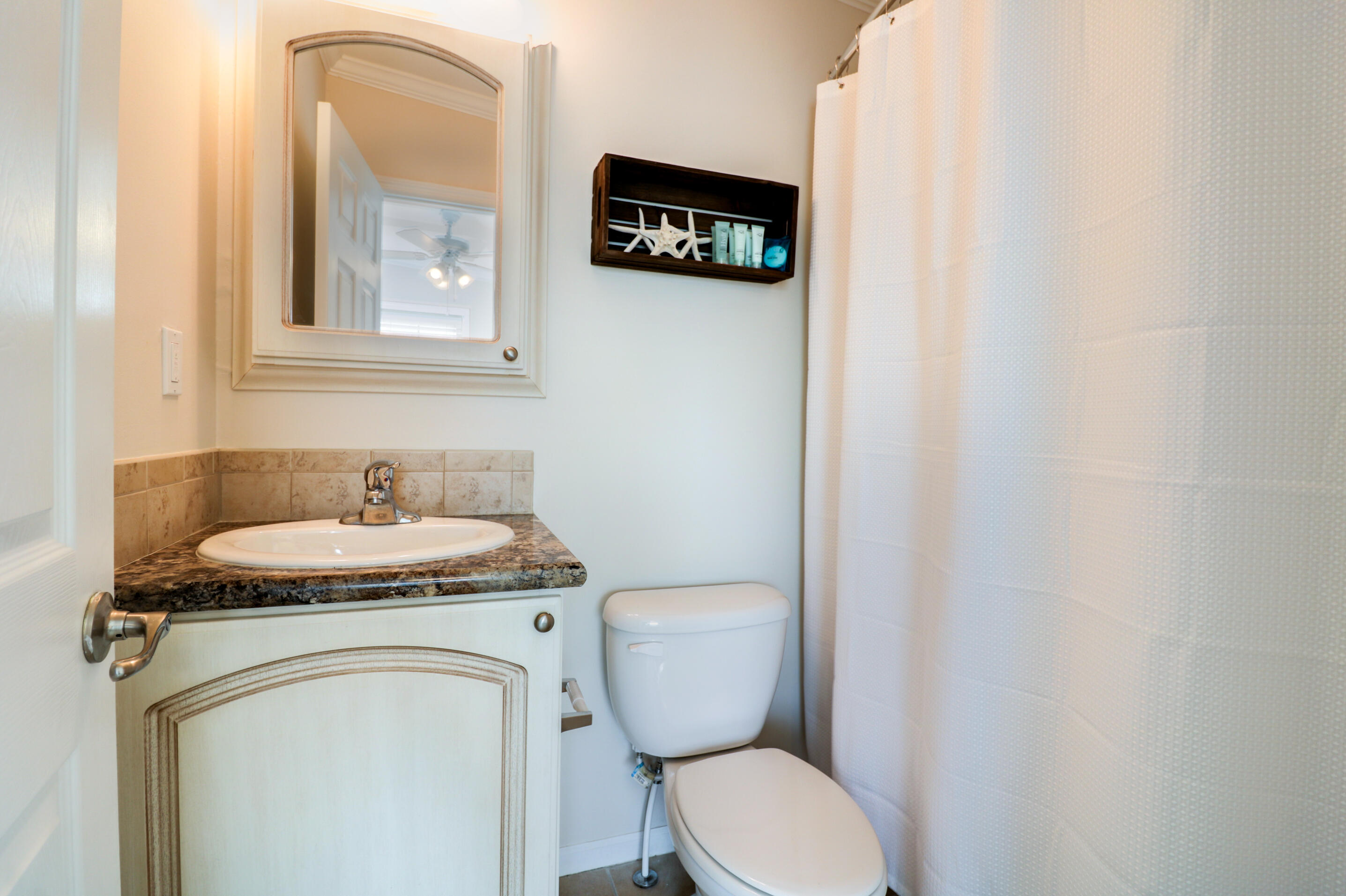 28515 Channel View Drive Summerland Key, FL 33042 - Photo 9 of 13 a bathroom with a toilet a sink and a mirror