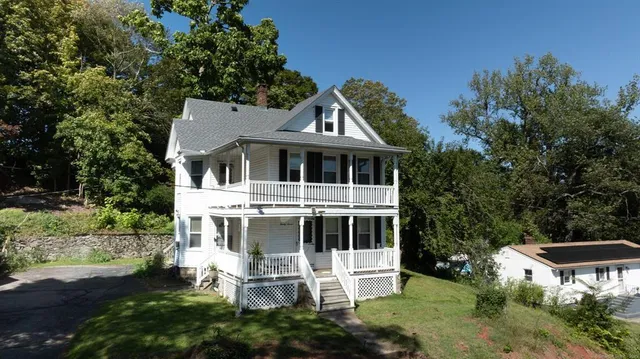 a aerial view of a house with a yard and potted plants