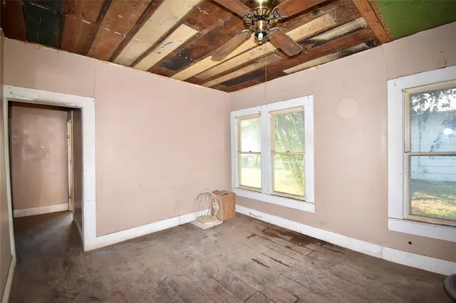 a view of a room with wooden floor and windows