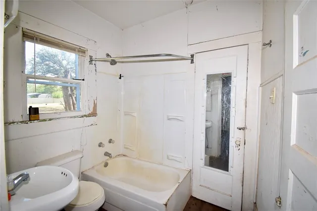 a view of hallway with windows and chandelier