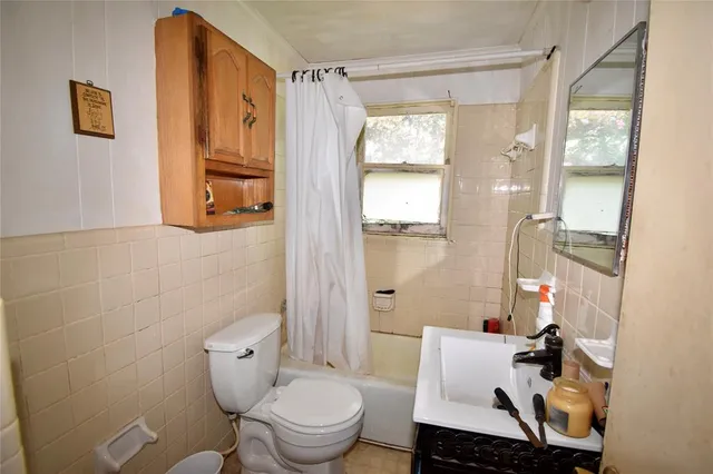 a bathroom with a toilet a sink and a shower