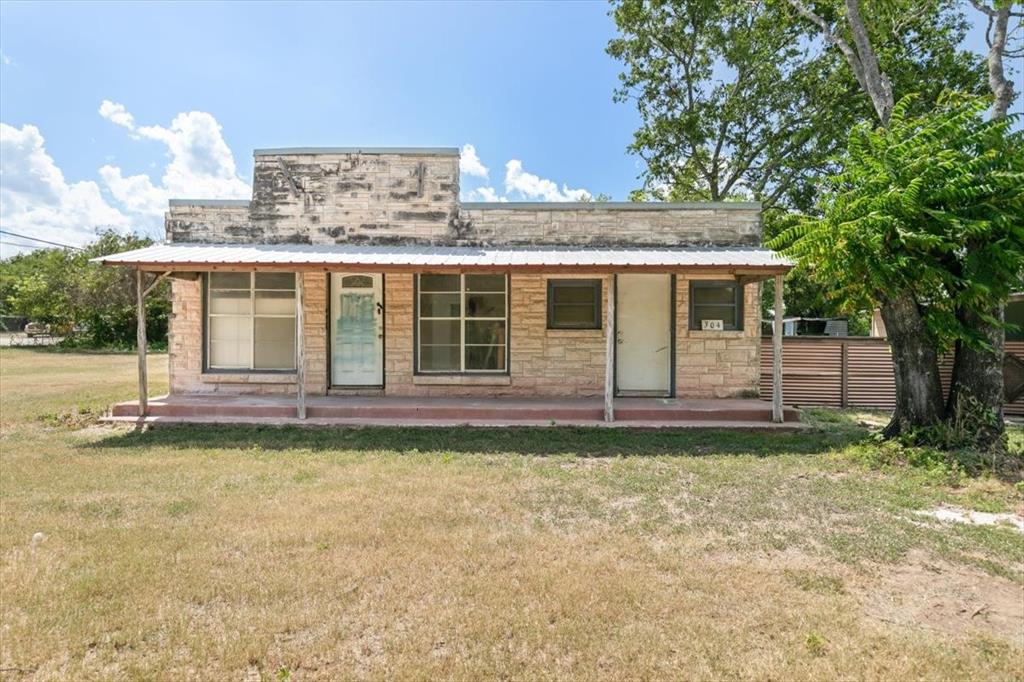 304 South Colorado Street Whitney, TX 76692 - Photo 19 of 32 a view of a house with a backyard