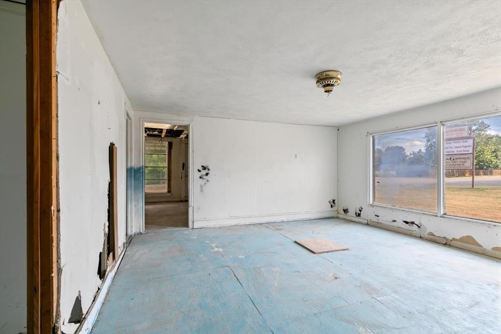 304 South Colorado Street Whitney, TX 76692 - Photo 25 of 32 an empty room with a empty space and windows