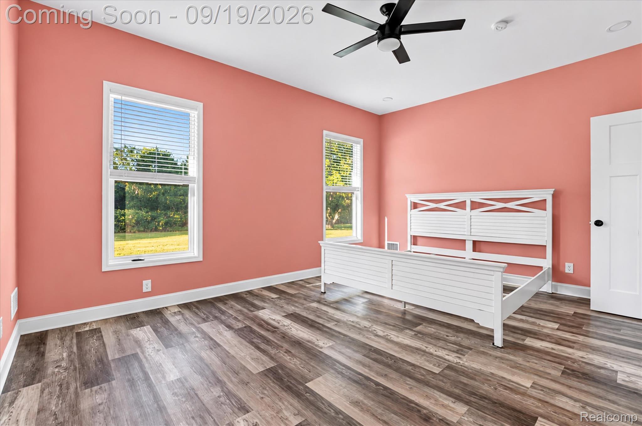 10215 West Mount Morris Road Flushing, MI 48433 - Photo 30 of 58 Wood-finish flooring with white trim, dual windows, and an overhead ceiling fan