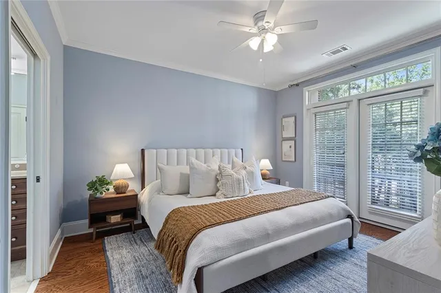 a bedroom with bed and a chandelier