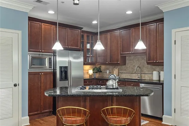 a kitchen with granite countertop wood cabinets and a sink