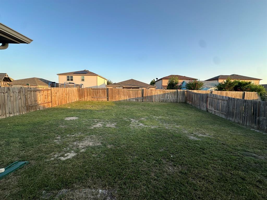1818 Clegg Street Howe, TX 75459 - Photo 31 of 34 Expansive backyard featuring a full perimeter wood privacy fence and a broad grass lawn
