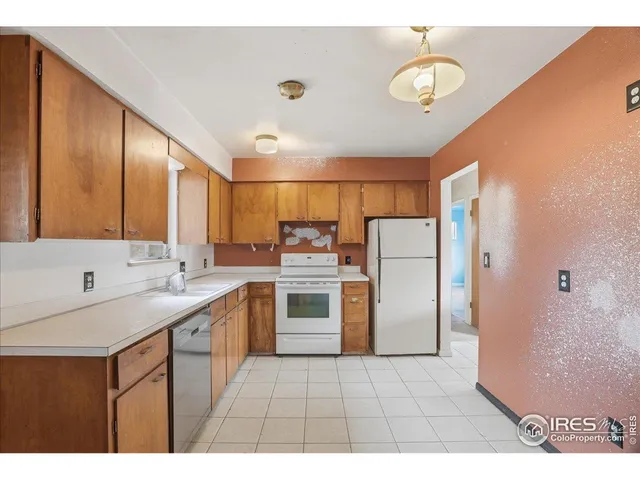 a kitchen with a sink a refrigerator and a stove