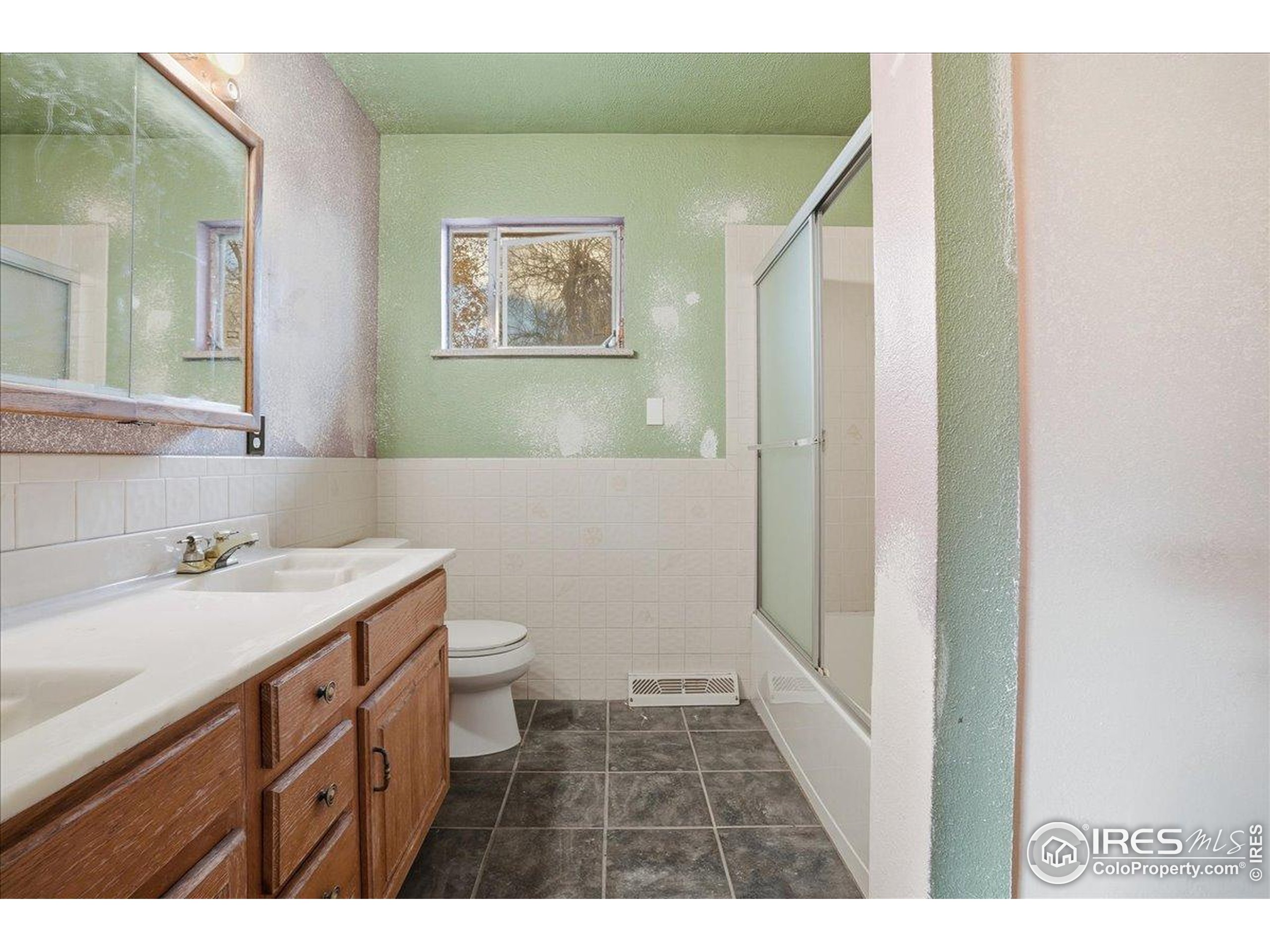 1113 Fairview Drive Fort Collins, CO 80521 - Photo 16 of 35 a bathroom with a sink a toilet and a mirror