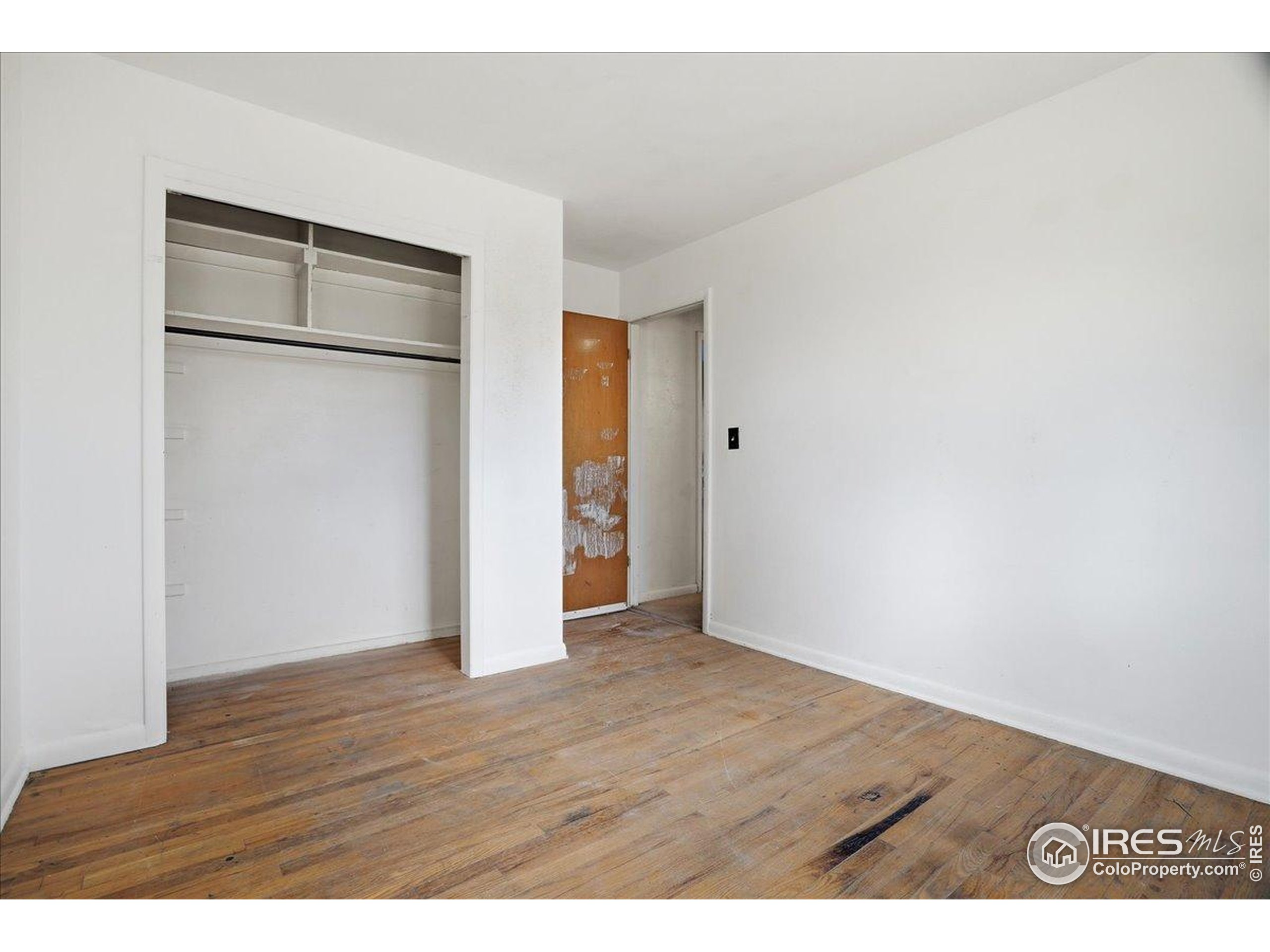 1113 Fairview Drive Fort Collins, CO 80521 - Photo 18 of 35 a view of an empty room with wooden floor and a window