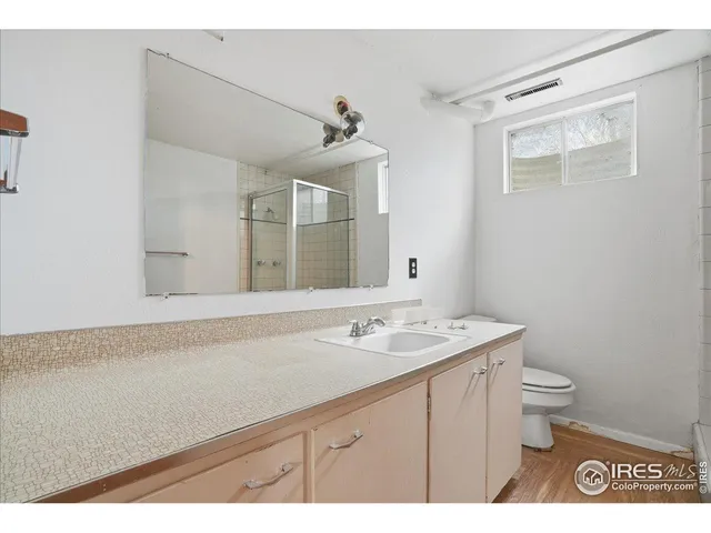 a bathroom with a sink a toilet and mirror