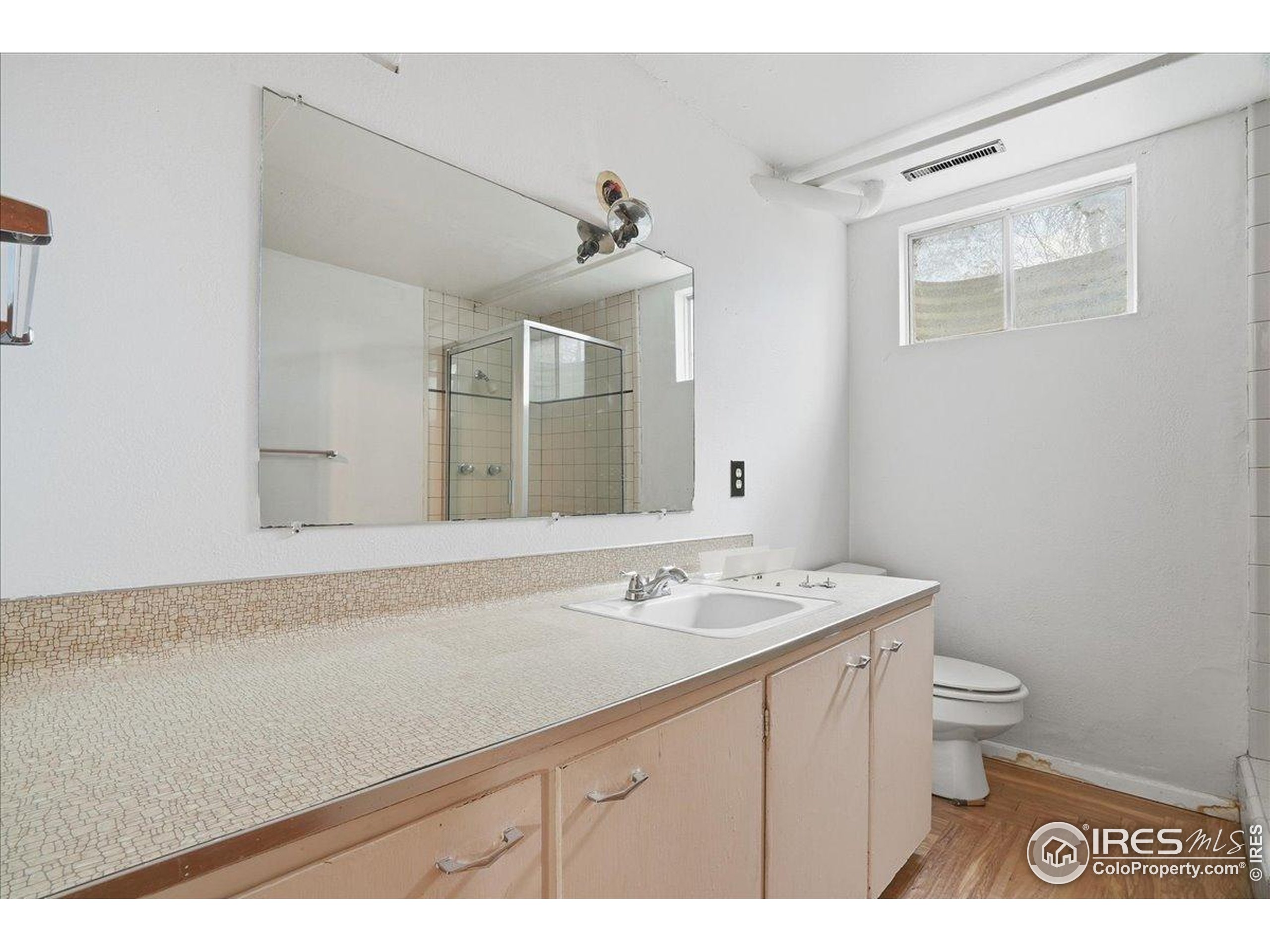 1113 Fairview Drive Fort Collins, CO 80521 - Photo 22 of 35 a bathroom with a sink a toilet and mirror