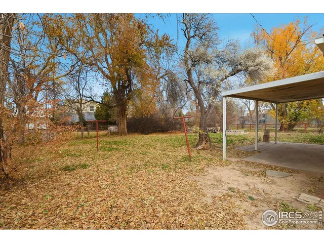 a view of backyard with wooden fence