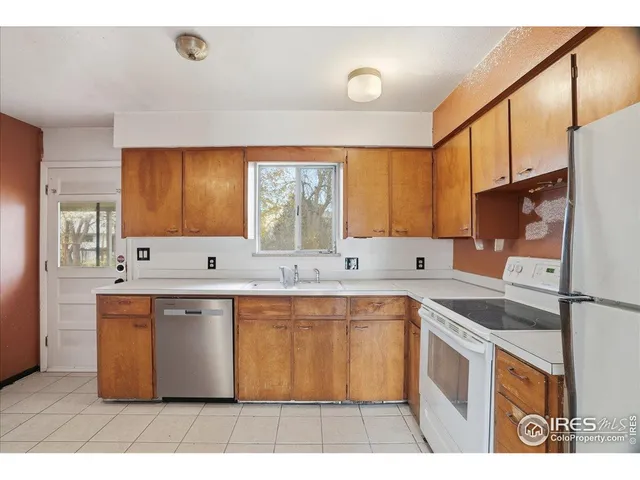 a kitchen with stainless steel appliances granite countertop a sink and a stove
