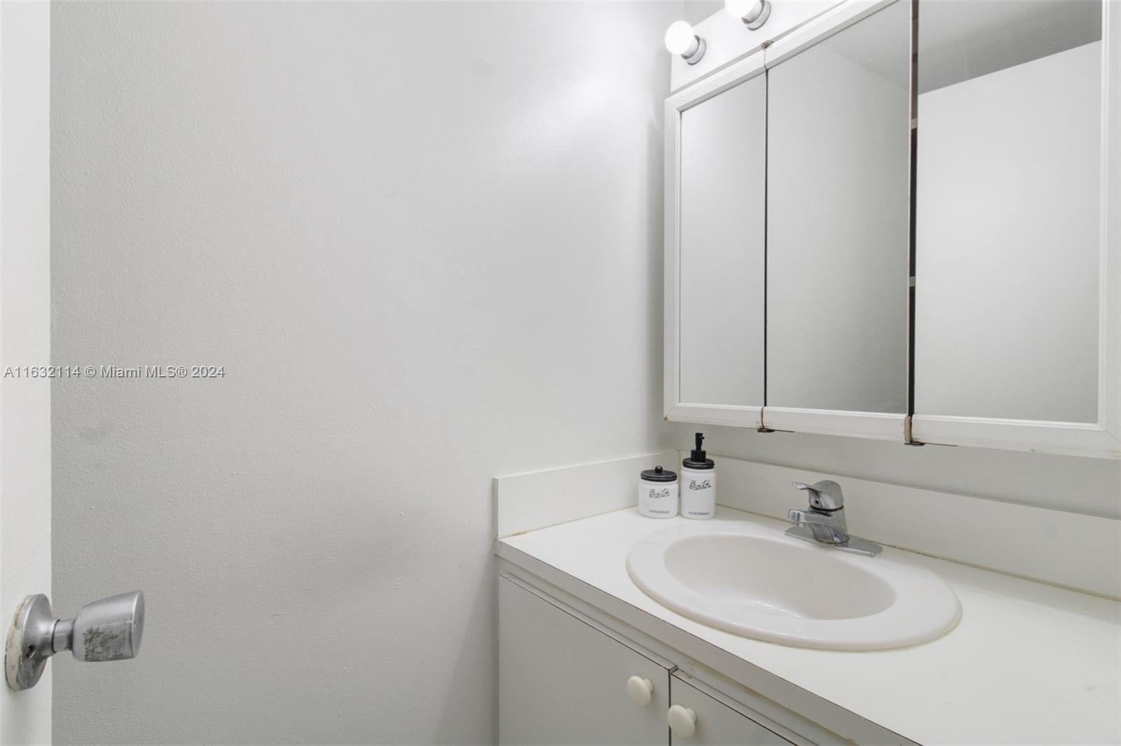 937 Michigan Avenue, Unit 4 Miami Beach, FL 33139 - Photo 4 of 20 a bathroom with a sink and a mirror